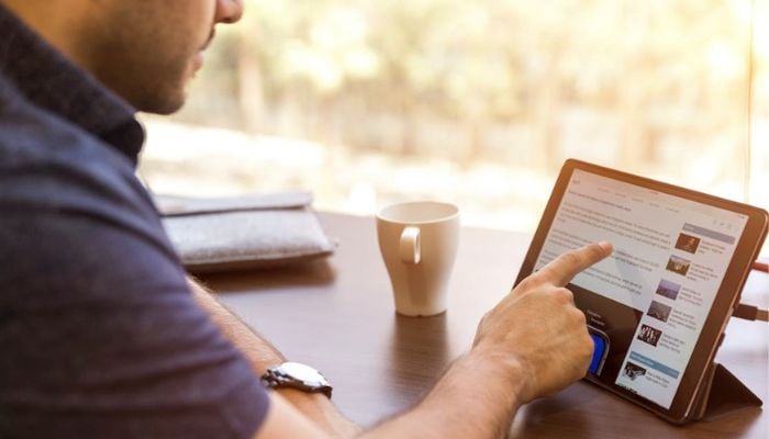 Image of a person using an iPad. — Pexels