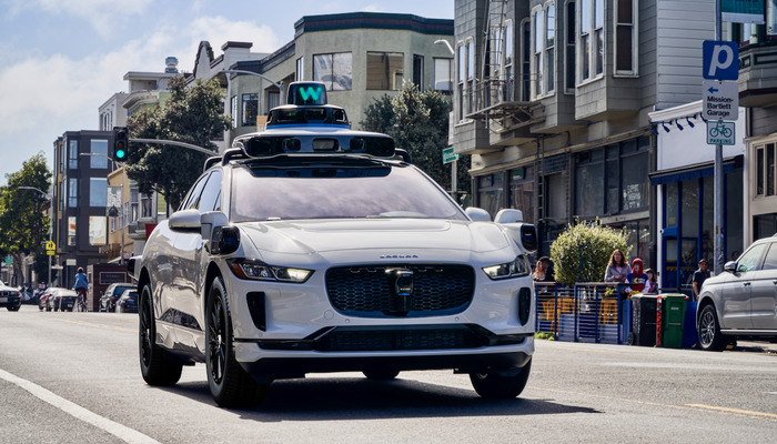 The image shows a Jaguar I-Pace,  Waymo Ones cab. — Waymo