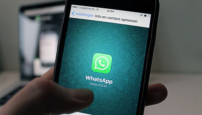 An undated image of a WhatsApp logo displayed on a mobile screen. — Canva