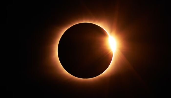 The image is an undated stock photo of a total solar eclipse. — Unsplash
