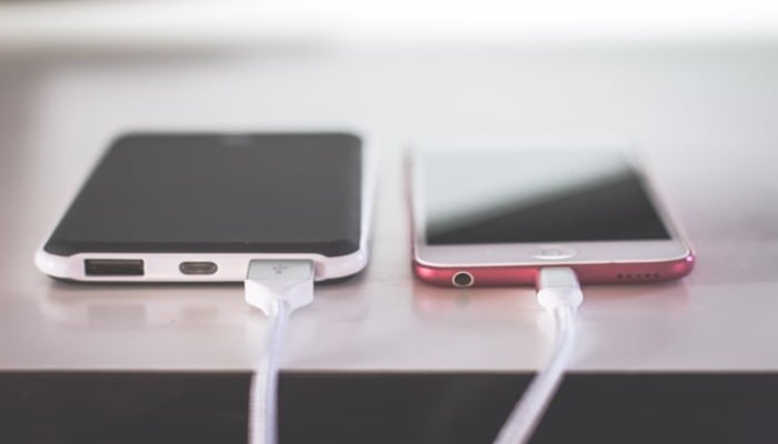 An undated image of two mobile phones on charge. — Unsplash