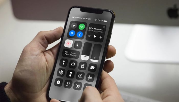 An undated image of a person using Control Centre on iPhone. — Unsplash
