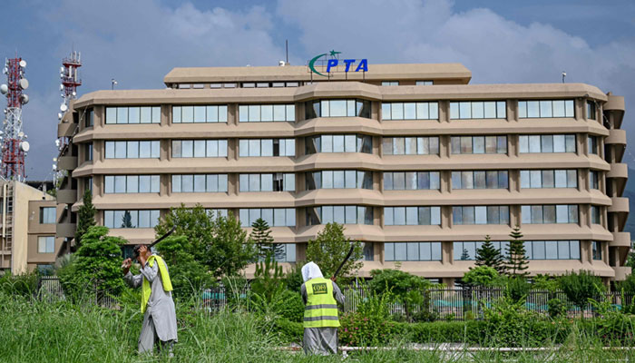 Image taken of people working near PTA headquarters in Islamabad on August 16, 2024. — AFP