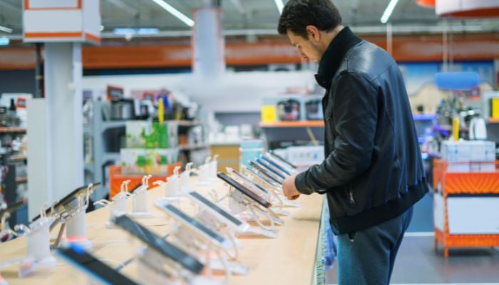 An undated image of a person in a mobile store. — Canva
