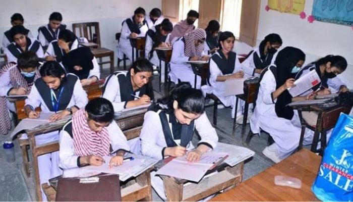 An undated image of female students giving exams in a government college. — APP