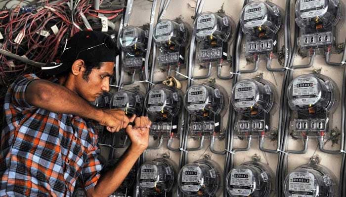 An undated image shows a power technician fixing electric meters in Pakistan. — AFP