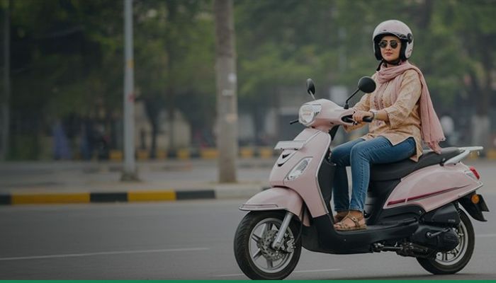 An undated image of a women riding a scooter. — Bank al Habib