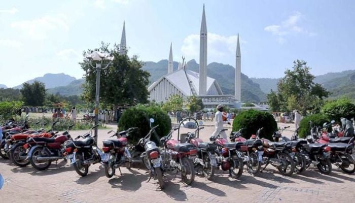 A large number of motorcycles are parked in the premises of Shah Faisal Masjid as people visit on the weekend. — APP