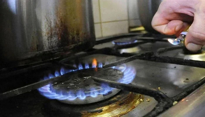 An undated image of a person lighting a stove. — AFP