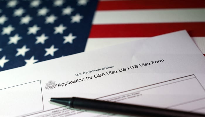 A U.S. flag and a U.S. H-1B Visa application form are seen in this illustration taken, September 22, 2025. — Reuters