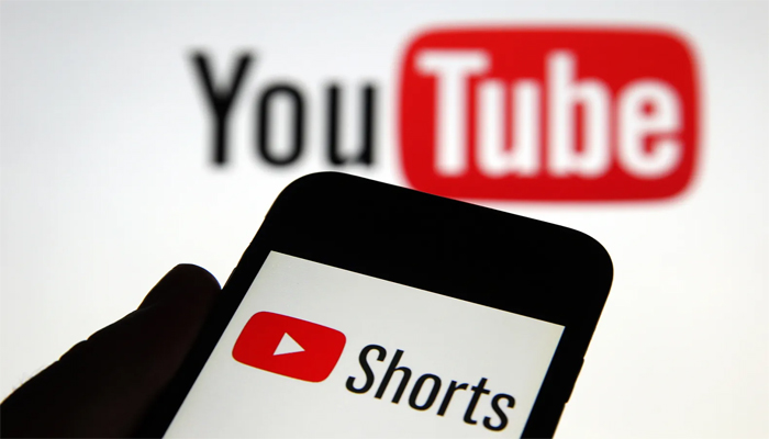An undated image shows Shorts on smartphone, along with YouTube on background. — Getty Images