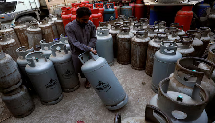 A Worker moves liquid petroleum gas (LPG) cylinder at workshop in Karachi, Pakistan September 17, 2018. — Reuters